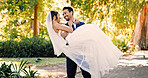 Wedding, groom and carry bride in nature for marriage celebration, relationship union and support. People, happy couple and lifting at park ceremony for love tradition, soulmate connection or bonding