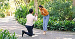 Couple, surprise and proposal with ring at park for marry me gesture, engagement and save the date. Unexpected, people or partner with marriage promise, emotional reaction and relationship commitment