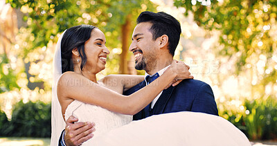 Buy stock photo Wedding, groom and carry bride outdoor for marriage celebration, relationship union and support. People, couple and lifting at ceremony in nature for love tradition, commitment and bonding together