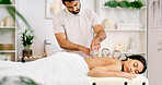 Man, woman and cupping on spa bed for blood flow benefits, detox and services at luxury resort. People, massage and glass with holistic wellness, circulation and therapy for inflammation at lodge