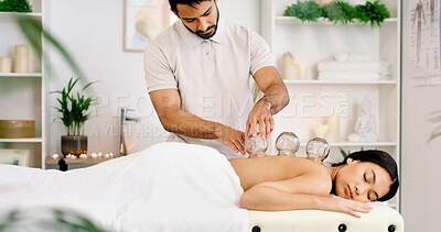Buy stock photo Man, woman and cupping on spa bed for blood flow benefits, detox and services at luxury resort. People, massage and glass with holistic wellness, circulation and therapy for inflammation at lodge