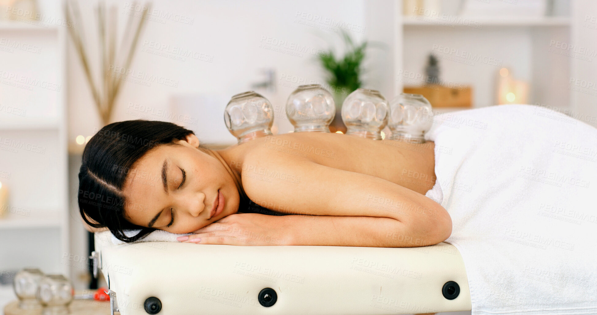 Buy stock photo Woman, sleeping or massage with cupping therapy for healing or muscle tension in beauty spa. Calm, female person or relax with suction cups for stress relief, relaxation or Chinese medicine in salon