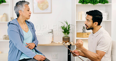 Buy stock photo Rehabilitation, chiropractor and mature woman with injury on arm, wellness and health question. Consultation, physiotherapist and person with pain, medical help or assessment with clipboard in clinic