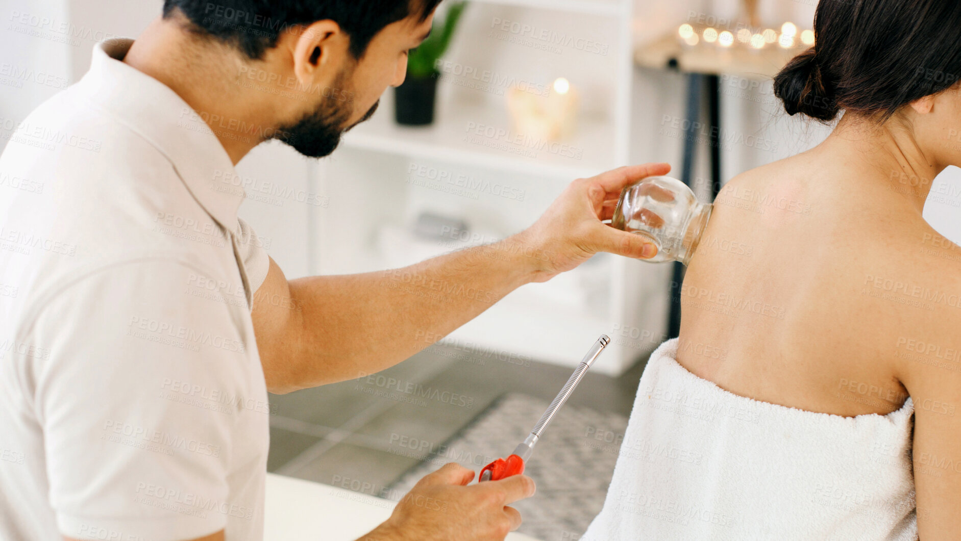 Buy stock photo People, glass and cupping therapy for back pain, health and healing for muscle blood flow benefits. Therapist, holistic spa and woman with man for wellness, relax or resort with deep tissue massage