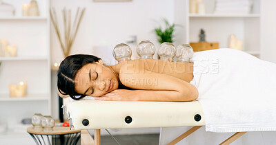 Buy stock photo Woman, relax or massage with cupping therapy for healing or muscle tension in beauty spa. Calm, female person or sleeping with suction cups for stress relief, relaxation or Chinese medicine in salon