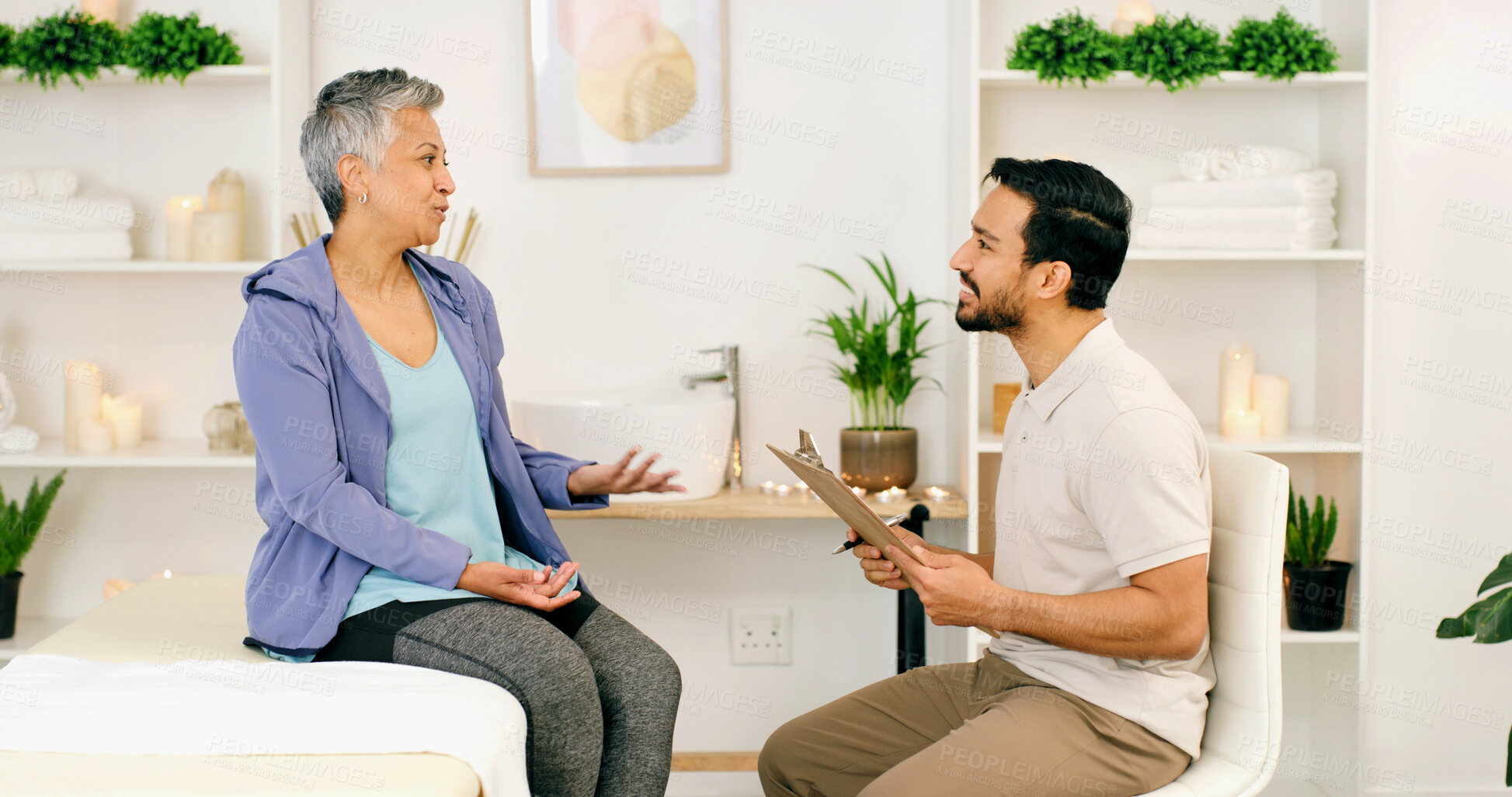 Buy stock photo Consultation, mature woman and physiotherapist in office for health, wellness or medical advice. Smile, person and physical therapist in clinic for healing, chiropractor and help with clipboard