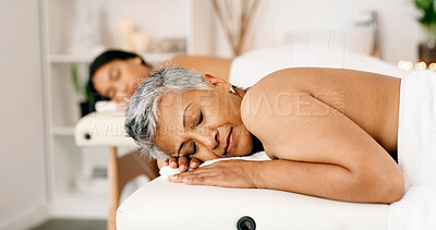 Buy stock photo Women, sleeping or acupuncture therapy with massage bed for spa, body treatment or healing in salon. Mature, female people or relax on holiday getaway together with comfort for zen or beauty session