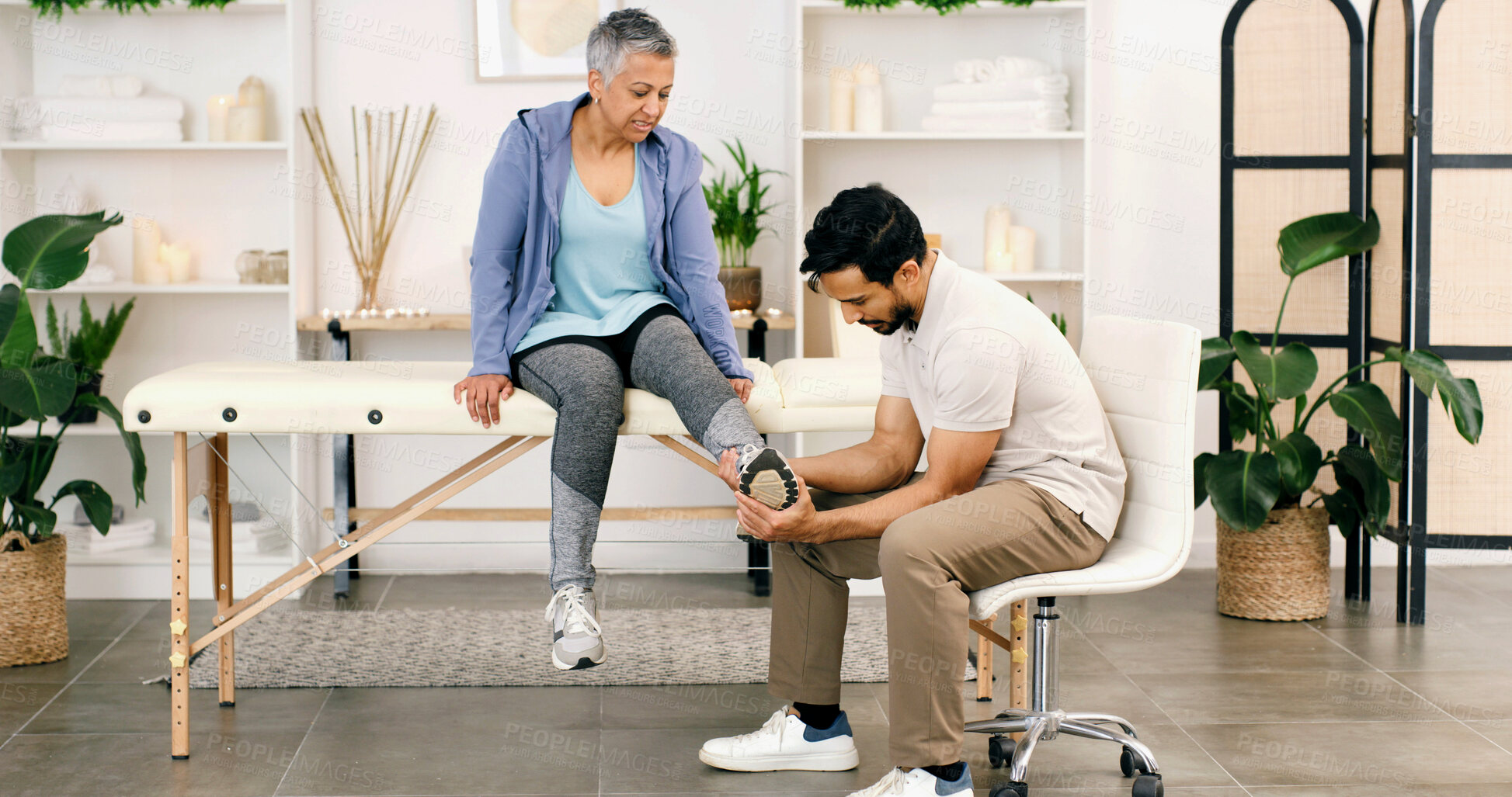 Buy stock photo Foot pain, physiotherapy and man with mature woman for consulting, wellness and rehabilitation. Healthcare, chiropractor and physical therapist with person for medical support, recovery and help