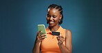 Happy, black woman and credit card with phone in studio for online shopping on a blue background. Female person, shopper or user with mobile smartphone or debit for banking app or ecommerce on space