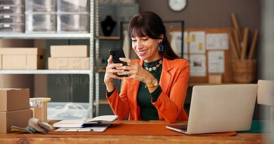 Buy stock photo Happy woman, online and smartphone in startup, reading order reviews on social media or supply chain. Laptop, positive feedback and mature person with mobile in small business, distribution and boxes