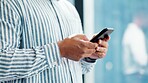 Hands, phone and typing with business person in glass office for financial feedback or update. App, finance and text message with employee in corporate workplace for accounting or risk management