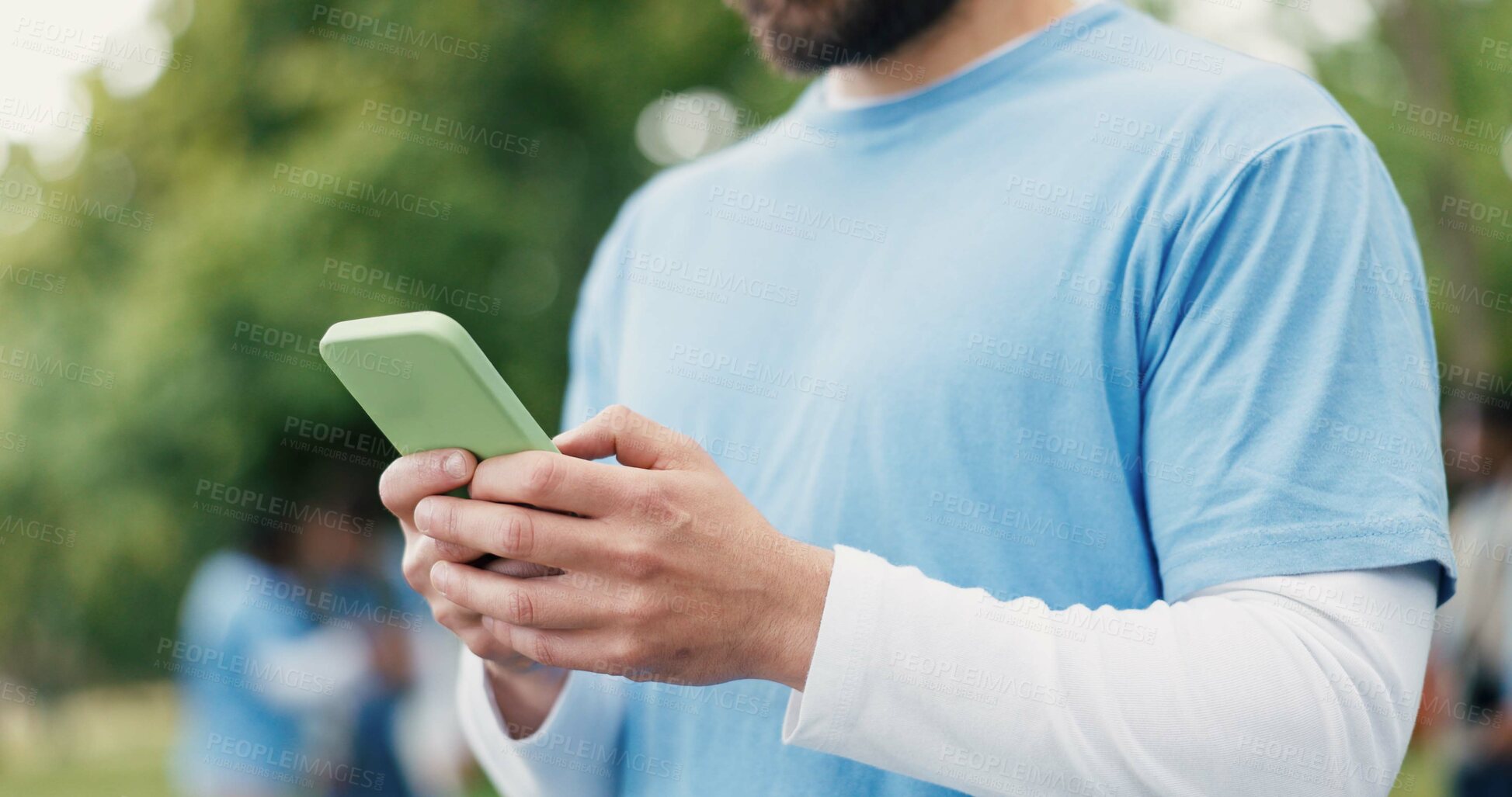Buy stock photo Hands, phone and volunteer with man in park for charity, community outreach or food drive. App, text message and typing with person outdoor for activism, ngo communication or non profit donation