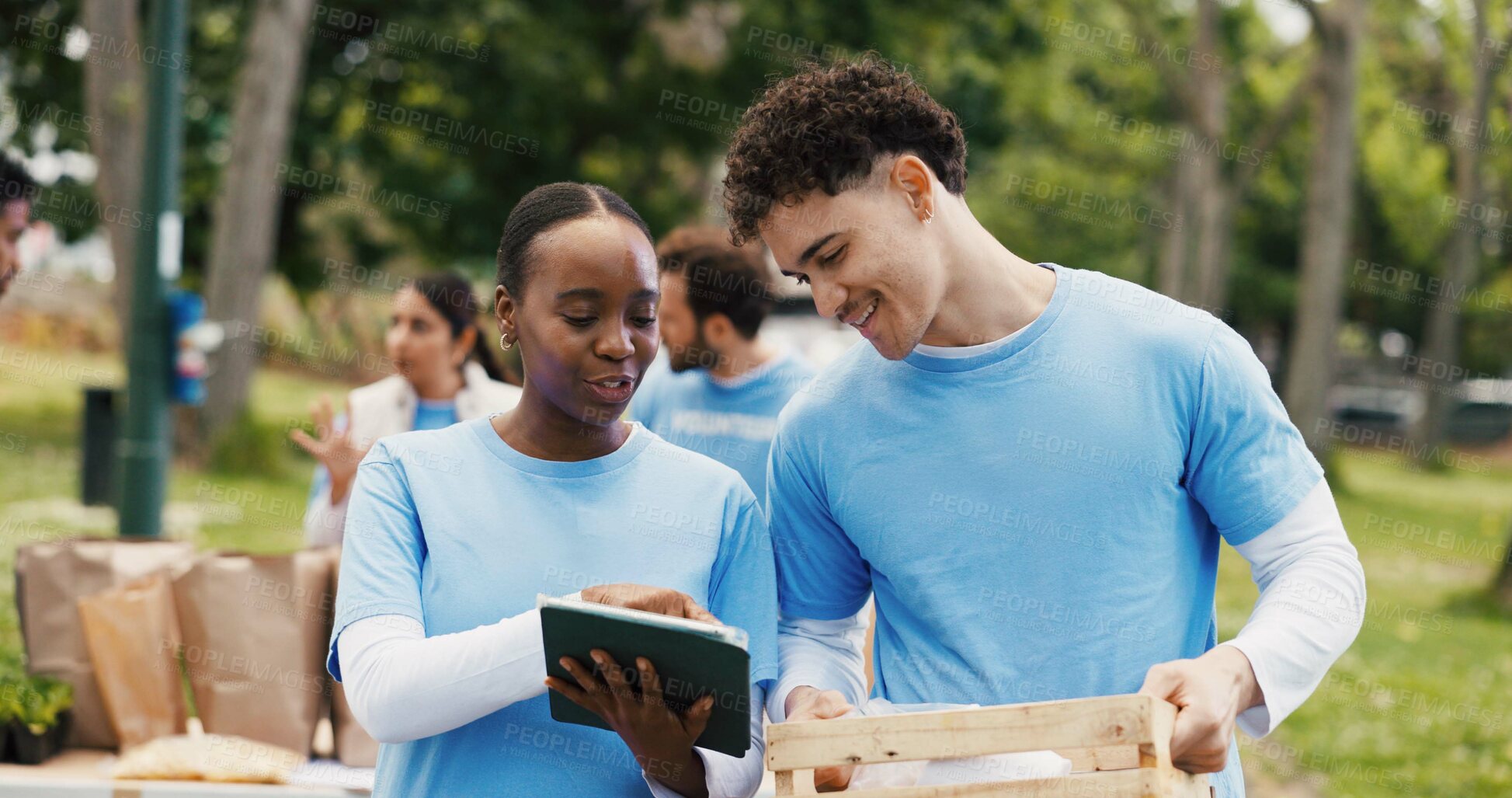Buy stock photo Outdoor, volunteers and discussion with tablet, charity and happy for inventory on web or donations. Humanitarian, people and supply distribution with tech, NGO and social responsibility in woods