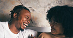 Home, funny and couple on couch, love and bonding together with smile, talking or trust. Laughing, happy man or woman with conversation, relax or relationship with comfort, humor or romance in lounge