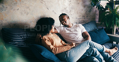 Buy stock photo Home, smile and couple on sofa, love and bonding together with comfort, talking and romance. Laughing, happy man and woman on couch, relax or relationship with discussion, humor or trust with break