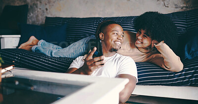 Buy stock photo Love, couple or relax with phone in home for watching online videos, status update or lazy weekend. Happy, african people and chill with mobile app on sofa for social media, bonding and relationship