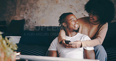 Buy stock photo Talking, couple and relax with phone in home for status update, social media meme or weekend break. Space, hug and african people with smartphone on sofa for online videos, bonding together and cozy