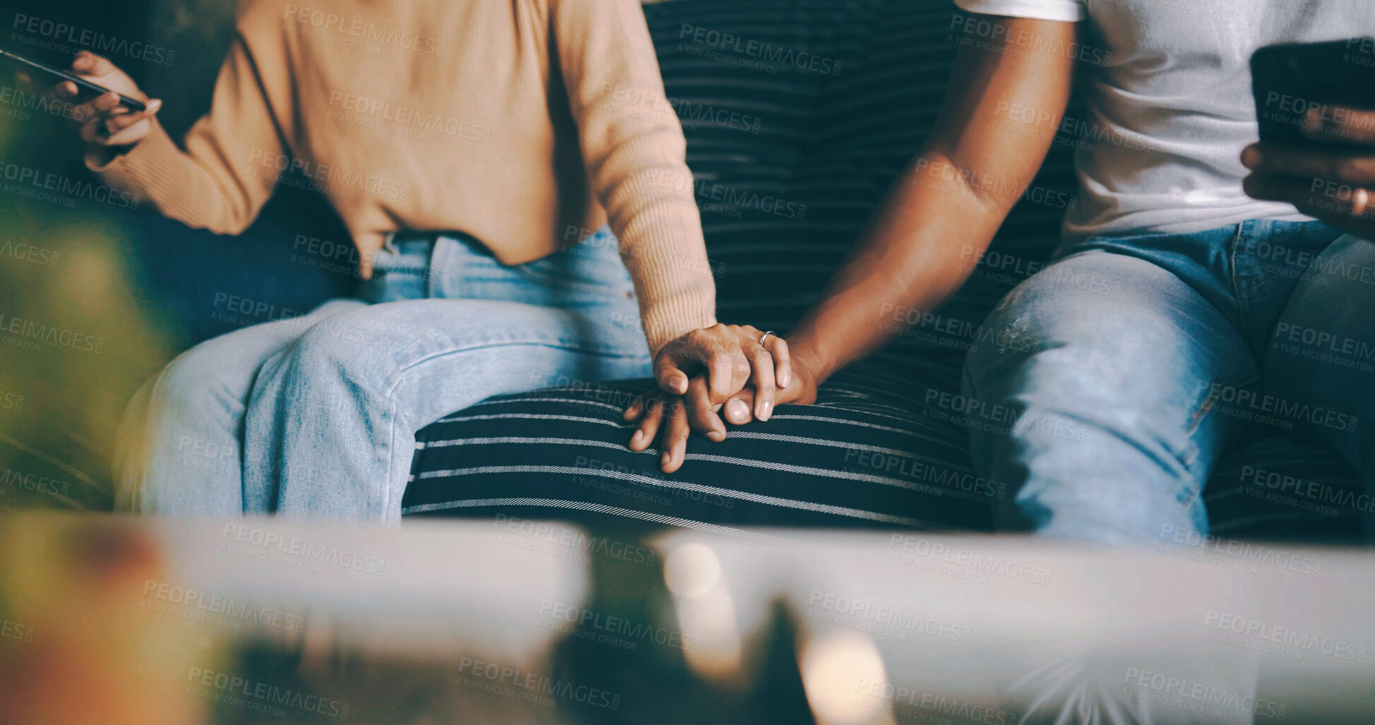 Buy stock photo Couple, sofa and holding hands with phone for trust, commitment or relationship together in home. Man, woman or touch with love, care or loyalty on mobile smartphone or couch for weekend in house