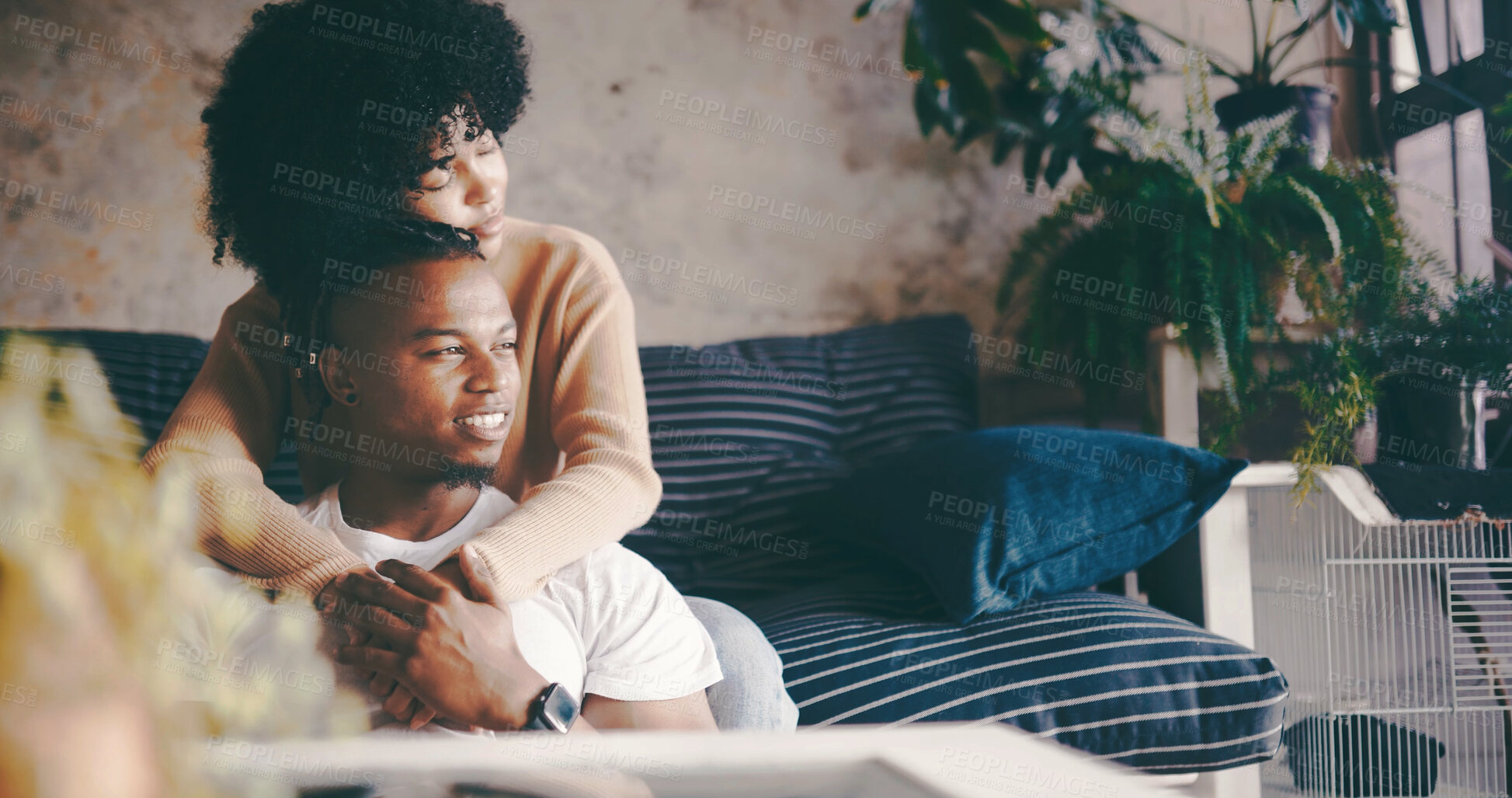 Buy stock photo Thinking, couple and hug in lounge, break and bonding on couch with smile, trust and romance in home. Happy, man and embrace with woman in living room, reflection and affection for partner in house
