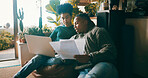 African couple, finance documents and laptop in home, talk o budget review in living room. People, happy and discussion with computer, planning or feedback with asset management paperwork in house