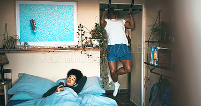 Buy stock photo Pull up bar, couple or phone in bedroom, home workout routine or check social media post for relationship. Fitness, watch video or people with mobile for connection, strength training or reading blog