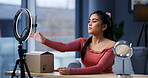 Girl, influencer and phone with ring light in home for unboxing, product review and prepare on web show. Person, content creator and recording tech with package, mobile app or social media at house