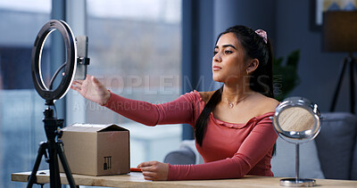 Buy stock photo Girl, influencer and phone with ring light in home for unboxing, product review and prepare on web show. Person, content creator and recording tech with package, mobile app or social media at house