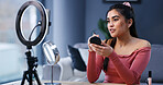 Ring light, woman and influencer with makeup brush for live streaming, beauty or tutorial. Cosmetics, foundation and person recording video on phone for aesthetic, glow and broadcast guide in home