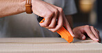 Open, hands and man with box cutter in home for ecommerce package, courier service and delivery. Apartment, unpacking and person with parcel for online shopping, order and shipping in living room