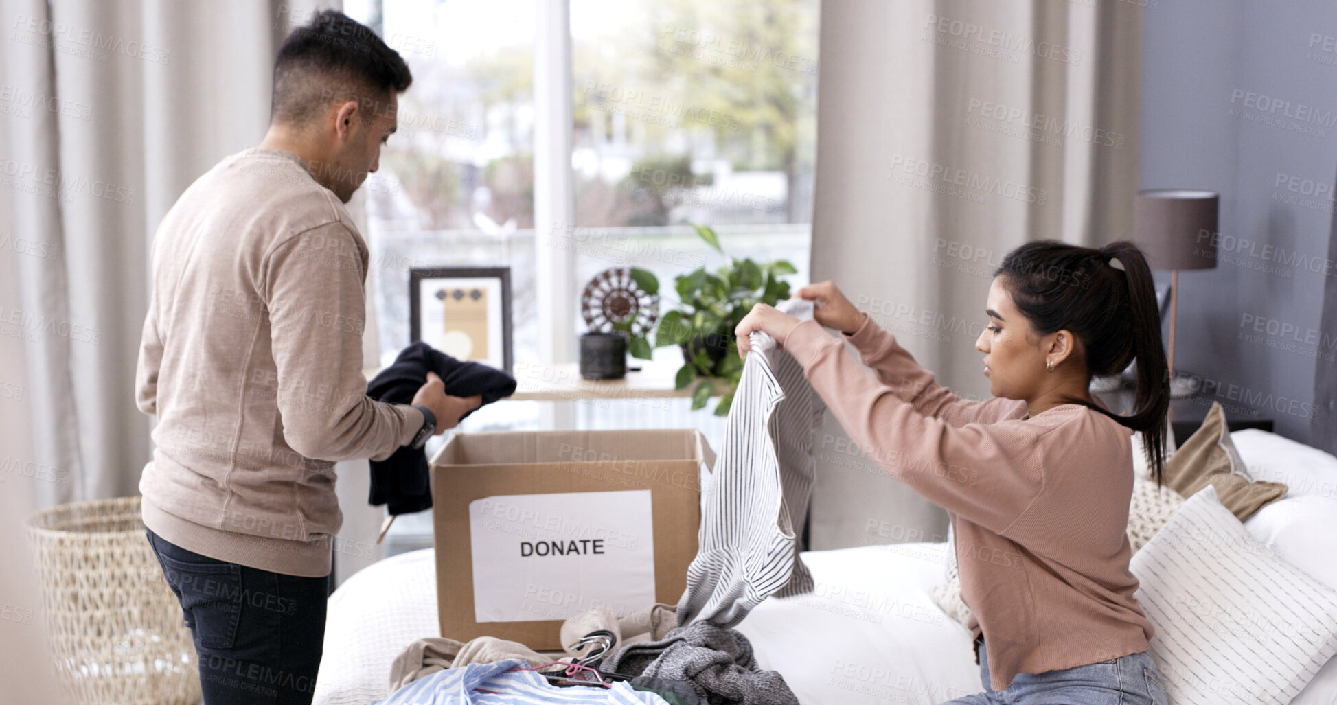 Buy stock photo Couple, folding clothes and donation box in home for charity initiative, nonprofit or declutter closet. Married people, apparel and giveaway in package for NGO contribution, support or clean bedroom.