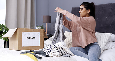 Buy stock photo Woman, folding clothes and donation box in home for charity initiative, nonprofit or declutter closet. Female person, apparel and giveaway in package for NGO contribution, support or spring cleaning.