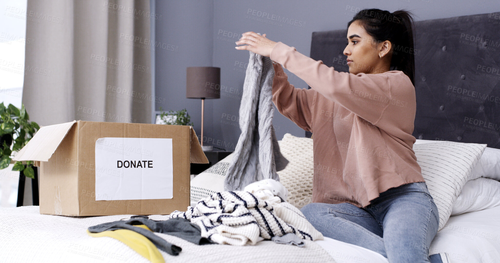 Buy stock photo Woman, folding clothes and donation box in home for charity initiative, nonprofit or declutter closet. Female person, apparel and giveaway in package for NGO contribution, support or spring cleaning.