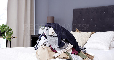 Buy stock photo Empty bedroom, clothes and pile of laundry, messy and fabric for housekeeping in home. Bed, dirty textile and unfolded clothing in room interior for chores, chaos and disorganized house in morning