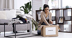 Woman, packing and box with clothing donation for charity, welfare or giveaway in home. Female person, volunteer or sorting with package to donate for community service or humanitarian aid in house