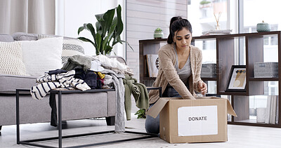 Buy stock photo Woman, packing and box with clothing donation for charity, welfare or giveaway in home. Female person, volunteer or sorting with package to donate for community service or humanitarian aid in house