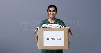 Buy stock photo Donation box, portrait or happy woman with clothes in studio, sustainable practice or giving to recycle. Social responsibility, space or person with apparel in cardboard, charity or gray background