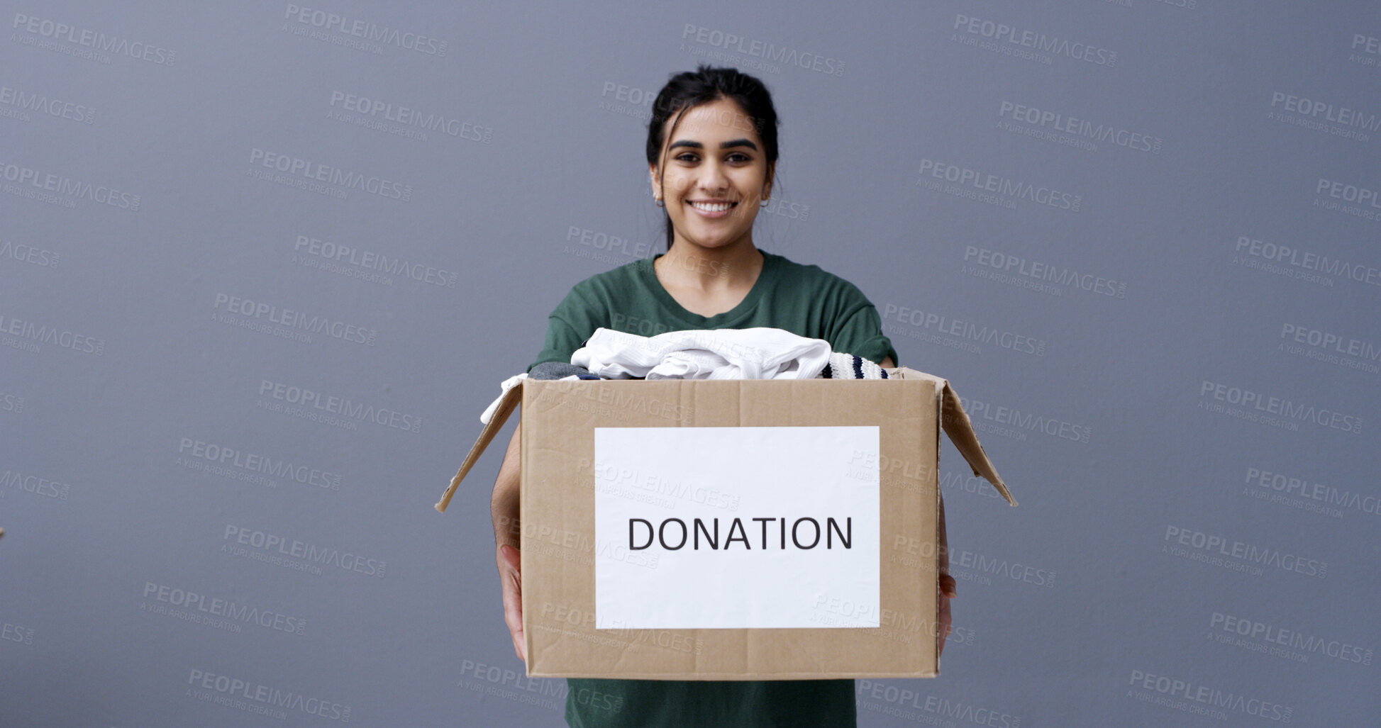 Buy stock photo Donation box, portrait or happy woman with clothes in studio, sustainable practice or giving to recycle. Social responsibility, space or person with apparel in cardboard, charity or gray background