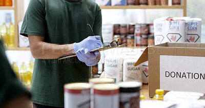 Buy stock photo Hands, donation and writing on clipboard for food drive, checklist and boxes at ngo center. Person, volunteer and notes with admin, gloves and product for poverty, accountability or nonprofit charity