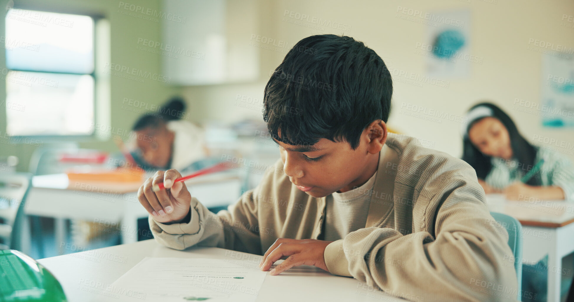 Buy stock photo Writing, education and quiz with boy in classroom for test, child development and knowledge. Studying, assessment and academy with student on school campus for learning, course curriculum and exam