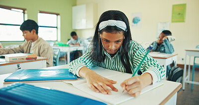 Buy stock photo Classroom, writing and child with notebook for learning, development and assessment for education. Knowledge, question solution and girl with pencil for assignment, concentration and problem solving