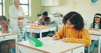 Buy stock photo Student, girl and writing in classroom with test for education, learning and skill development. People, child or notes in school with pencil for exam, academic assignment and assessment solution.