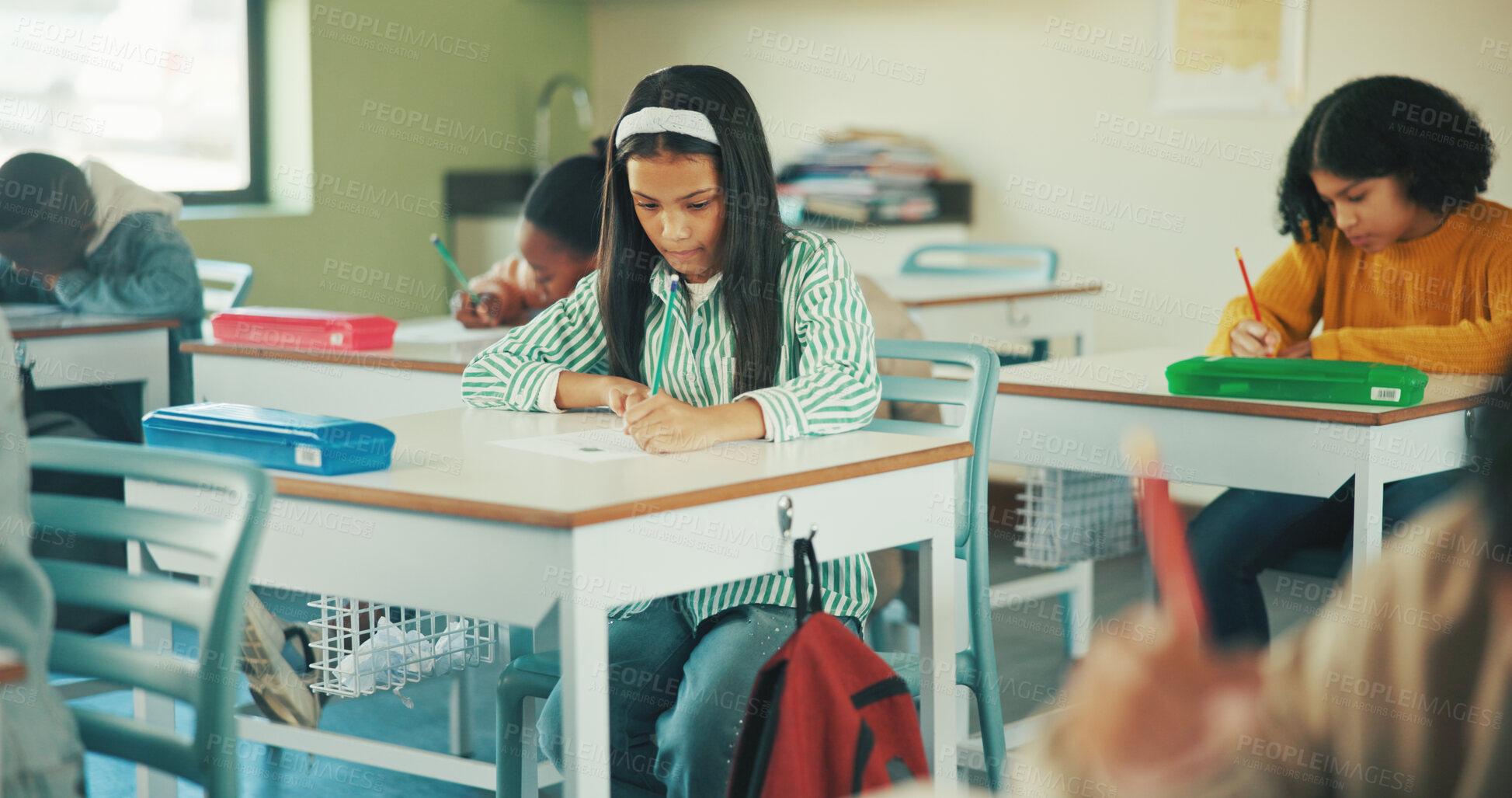 Buy stock photo Writing, education and quiz with girl in classroom for test, child development and knowledge. Studying, assessment and academy with student on school campus for learning, course curriculum and exam