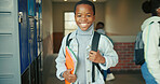 Books, education and portrait of boy at lockers for future, child development and knowledge. Studying, growth and academy with student in school campus for learning, course curriculum and smile