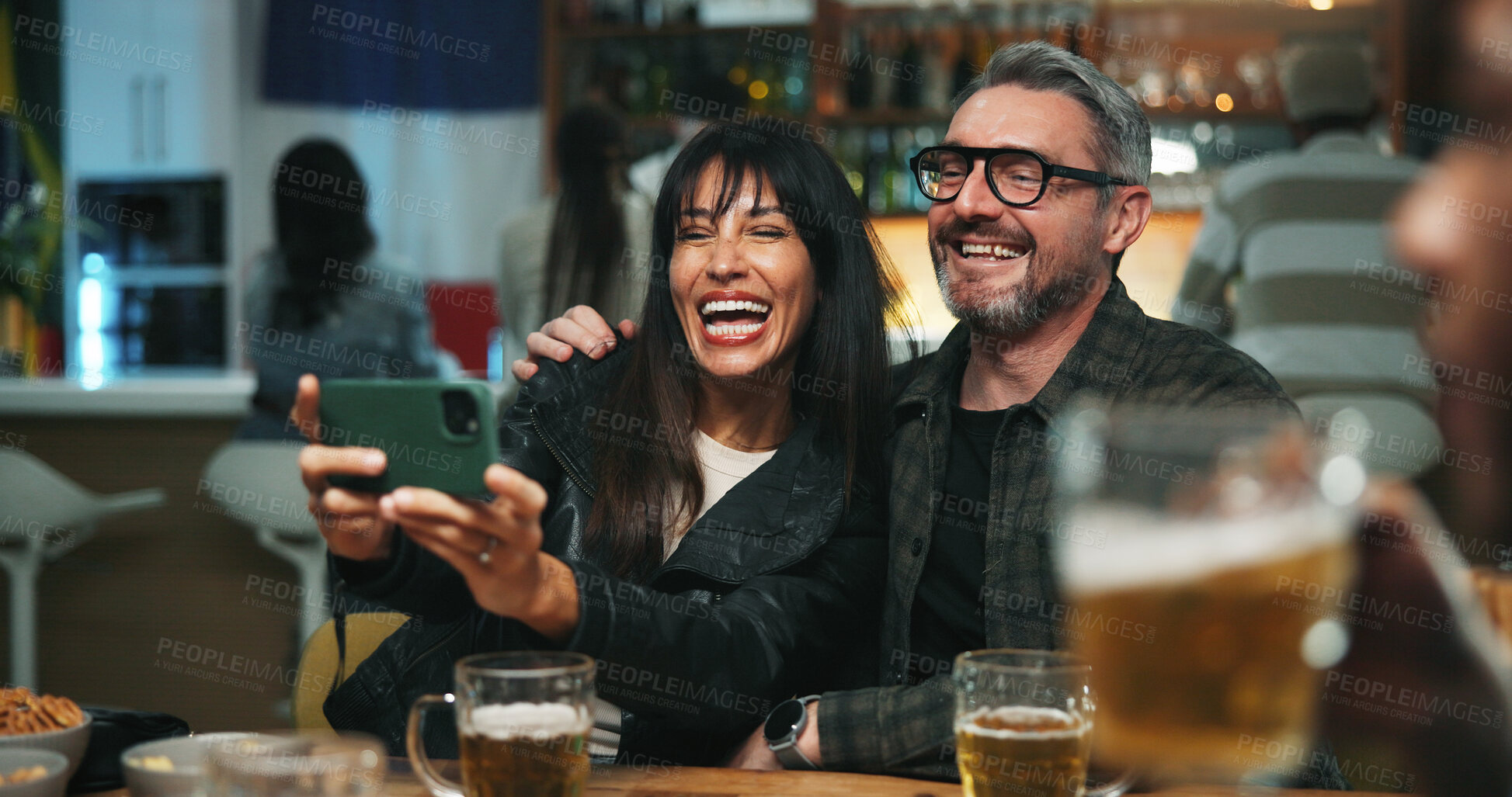 Buy stock photo Selfie, love and couple in pub, funny and bonding together with alcohol, relax and photography. Humor, man and mature woman with happiness, laughing and celebration with memory and profile picture
