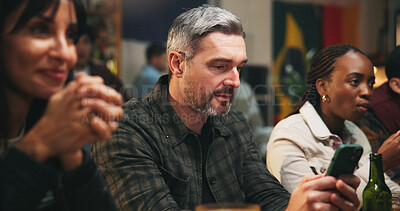 Buy stock photo Pub, group and man with smartphone, sports betting and checking game results for online competition. Watching, match and gambling with mobile app in bar, entertainment and football fans or people