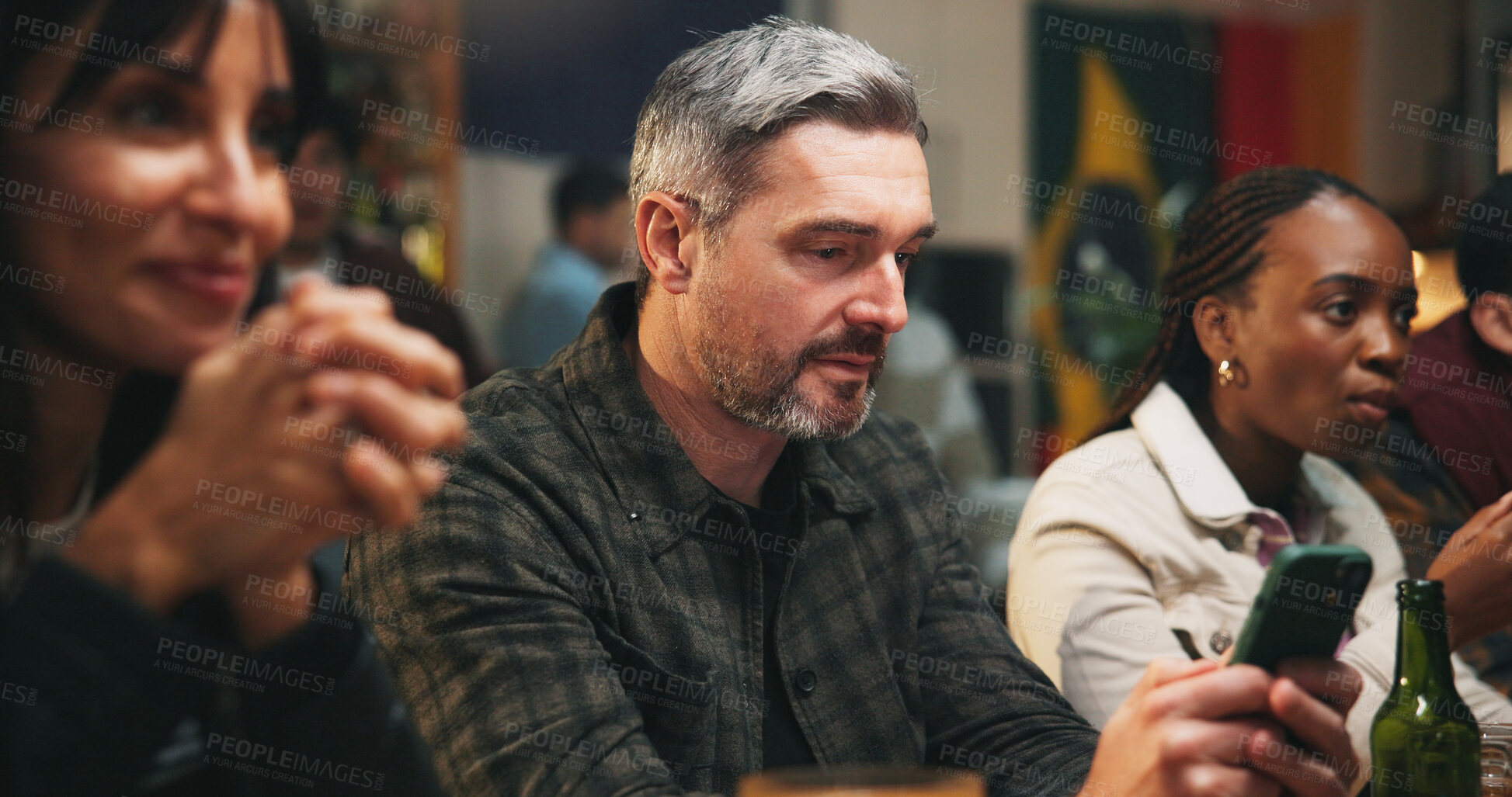 Buy stock photo Pub, group and man with smartphone, sports betting and checking game results for online competition. Watching, match and gambling with mobile app in bar, entertainment and football fans or people
