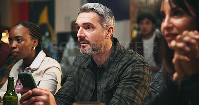 Buy stock photo Pub, group and man with smartphone, watching and checking game results for sports betting or online. Live stream, match and gambling with mobile app in bar, entertainment and football fans or people