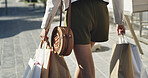 Back, shopping bags and woman in city, walking and spree with retail market, buying gifts and expensive. Outdoor, consumer and person with promotion, boutique product and travel with sales discount