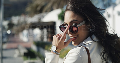 Buy stock photo Portrait, smile and sunglasses with woman outdoor for commute, fashion or travel on sidewalk. Back, eyewear style or walking and happy person with attitude in city for break, satisfaction or trip