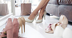 Woman, feet or fitting with high heels for shoe shopping, footwear or fashion style in boutique. Female person, shopper or legs with choice or decision for change in retail clothing store or shop
